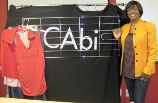 Novelett next to the Cabi Logo and the oodles of clothes she brought
